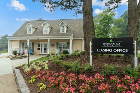 a building with a leasing office sign in front of it